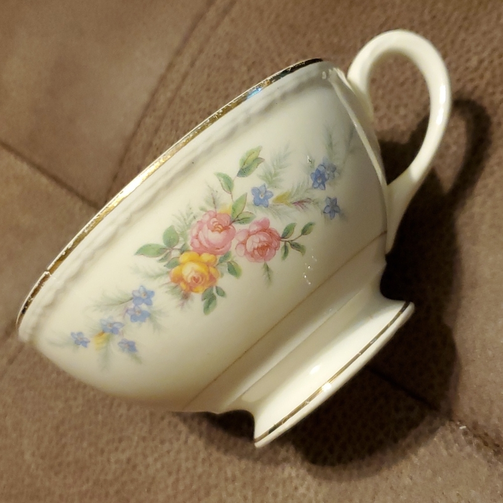 Vintage tea cup with roses, gold trim